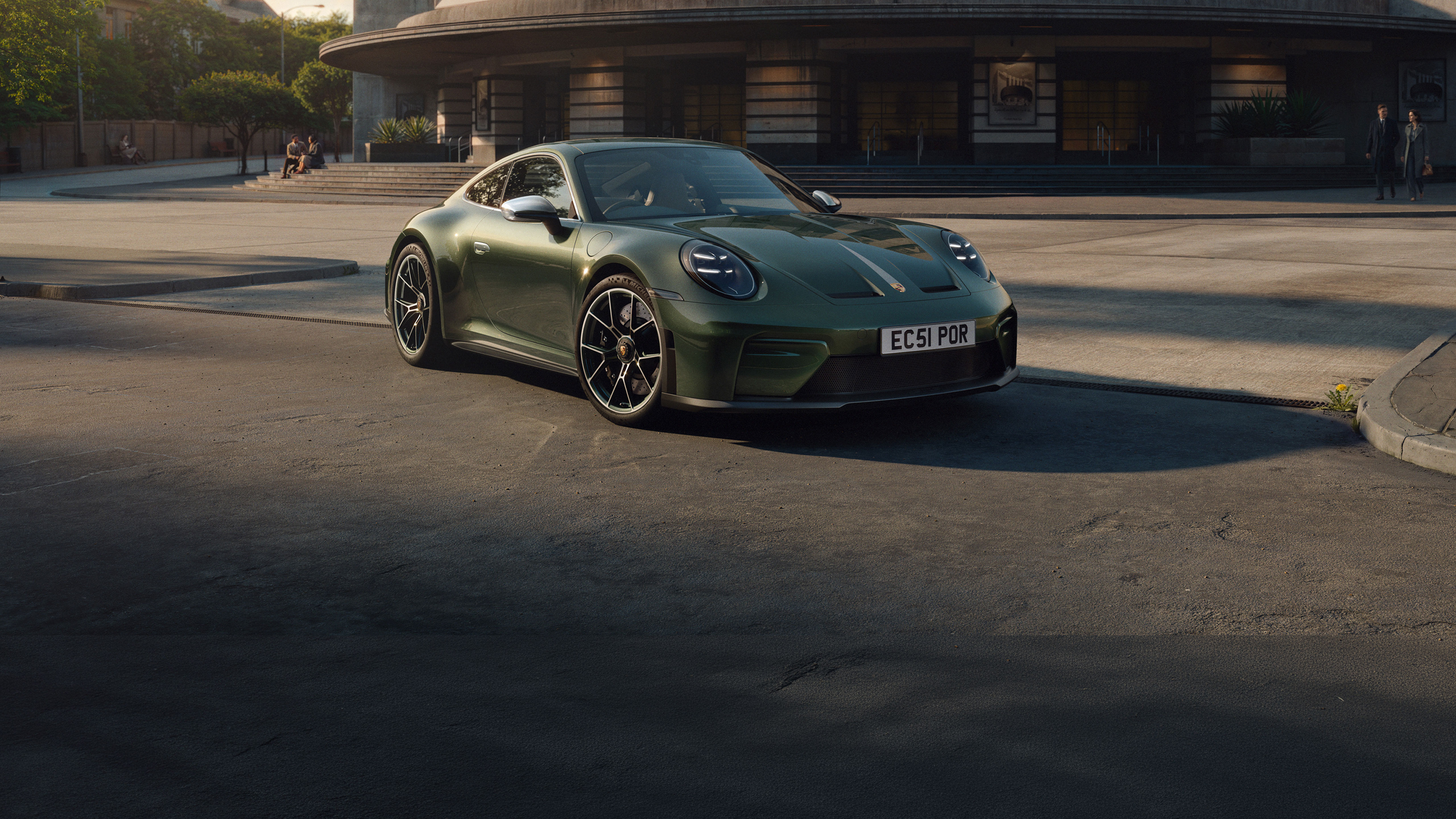 Green Porsche 911 GT3 Earls Court 51 Edition parked outside a curved building at golden hour